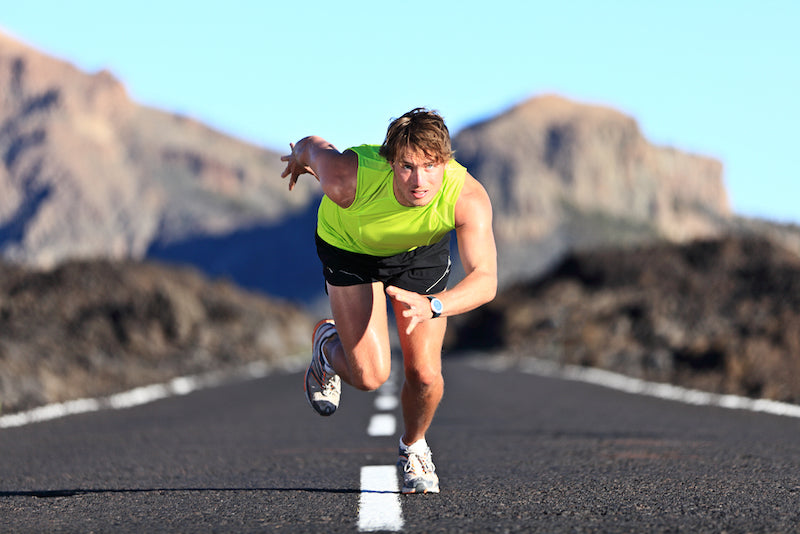 male athlete sprinting on road