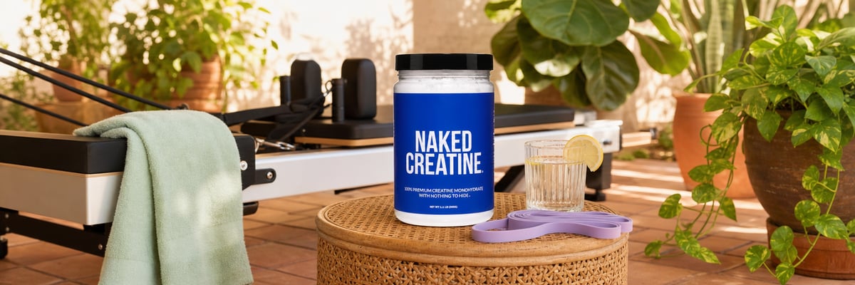 Naked Creatine tub on outdoor pilates patio with resistance band and water glass