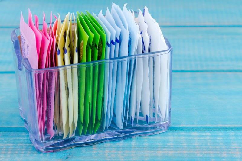 Packets of artificial sweeteners in a glass stand